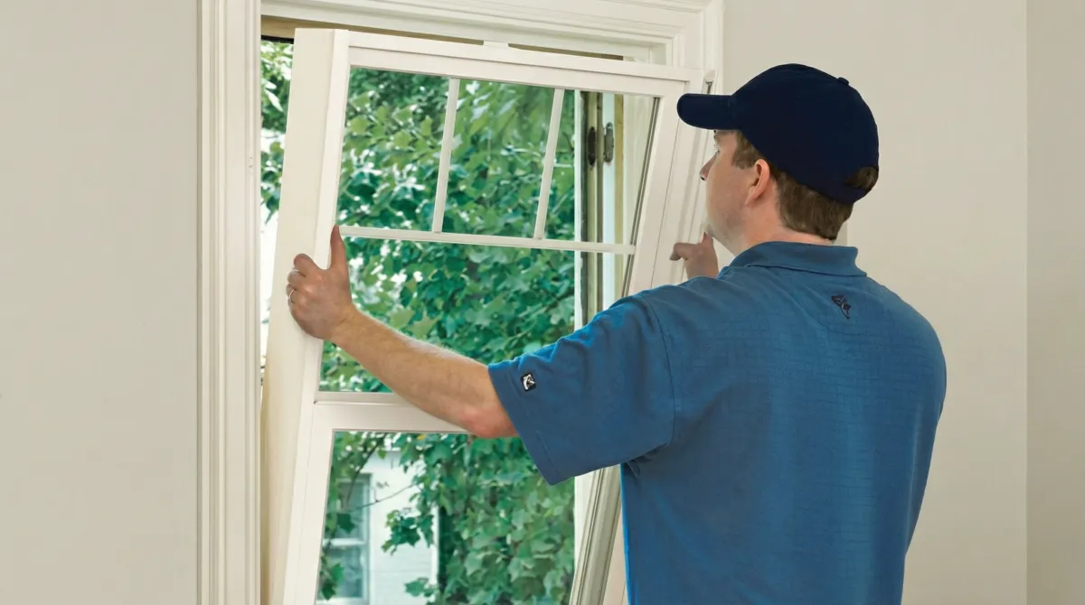 Professional contractors performing a residential window insulation and replacement service in Des Moines, IA